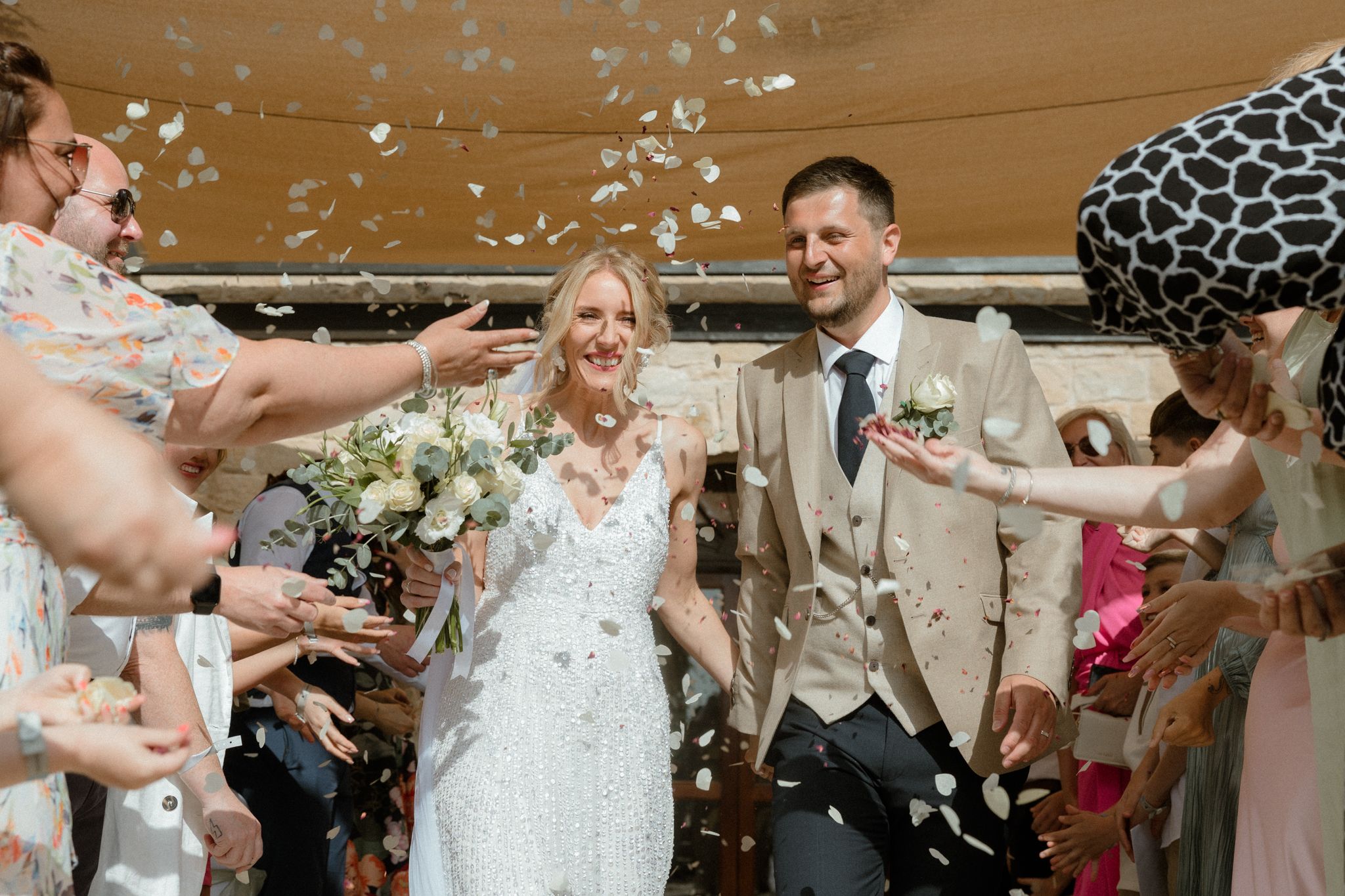 Confetti falls during a joyous wedding celebration. Cyprus wedding photographer. Candid moments, natural poses. Engagement shoot Paphos