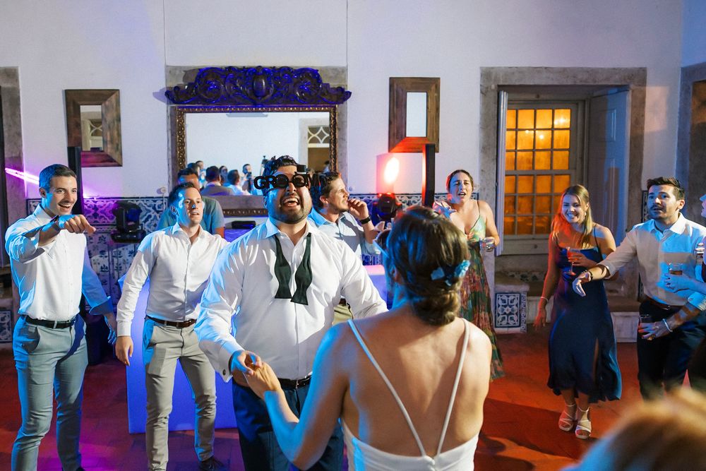 Bride and groom dancing surrounded by guests at Quinta do Torneiro wedding in Portugal with DJ