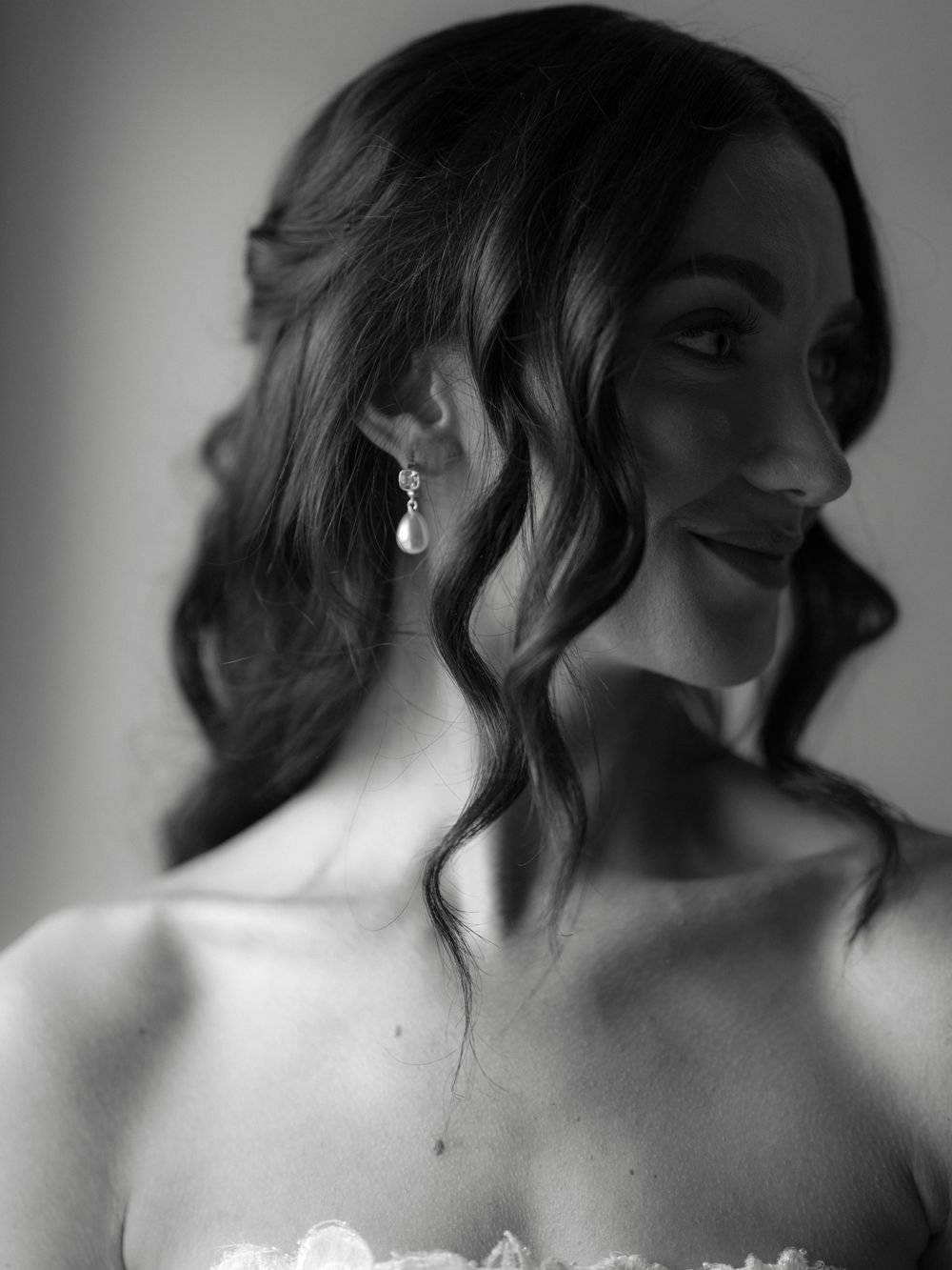 Close up black and white portrait series showing elegant poses and shoulder details with soft lighting.