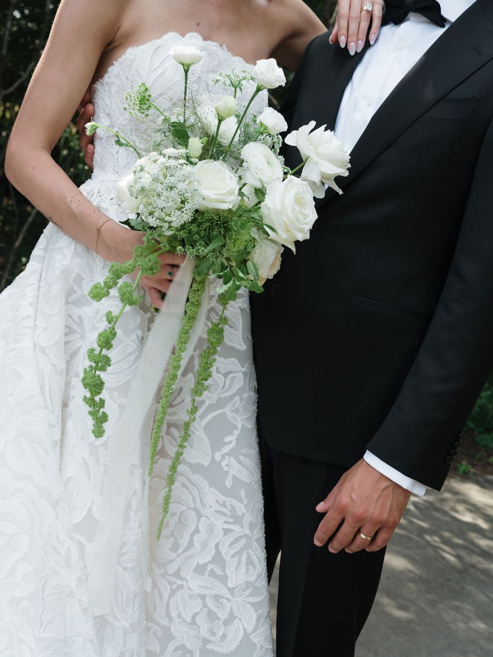 Elegant white wedding bouquet with cascading greenery and delicate flowers.