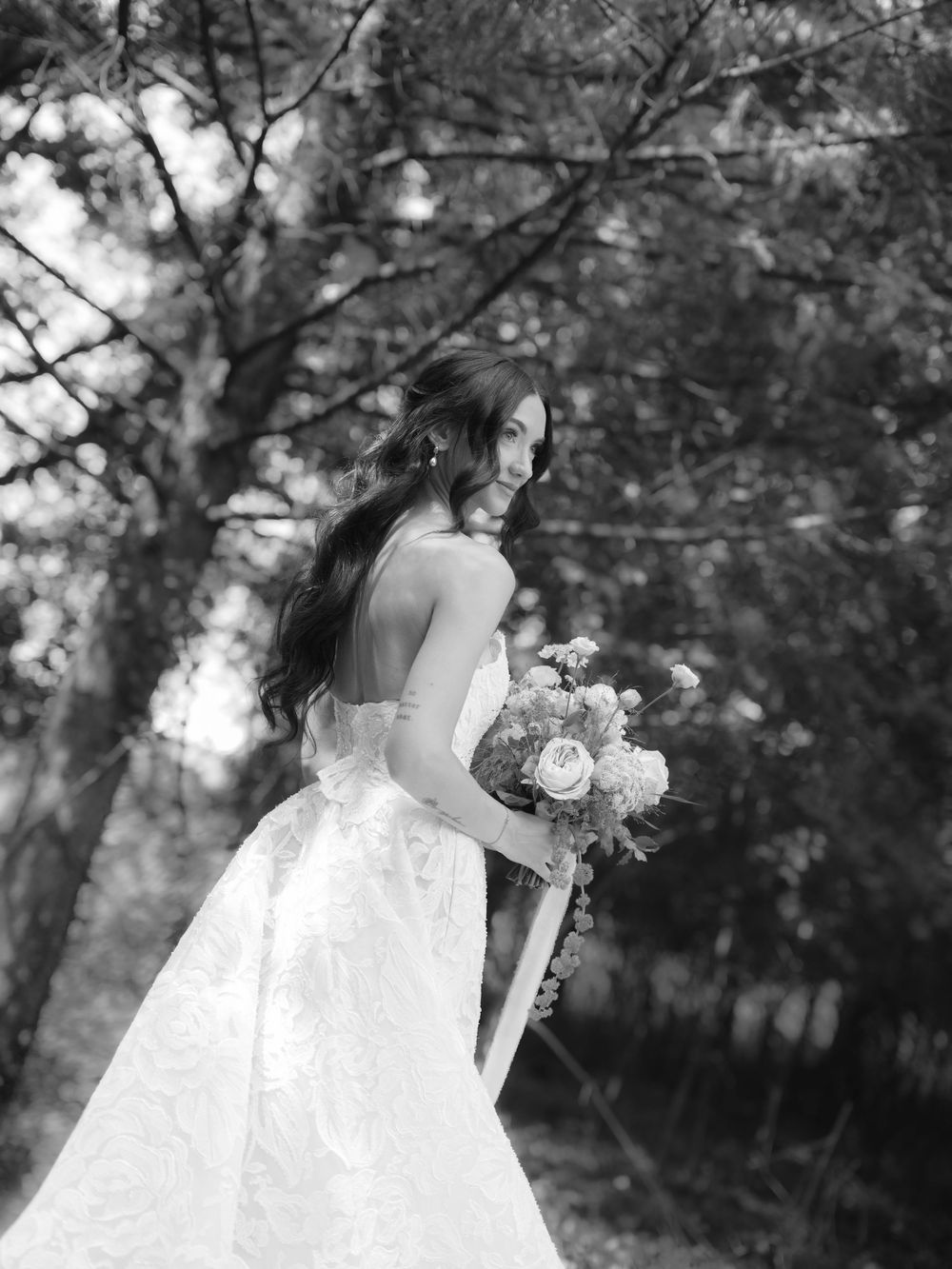 A series of romantic black and white wedding photos showing a bride holding a bouquet in an outdoor garden setting.