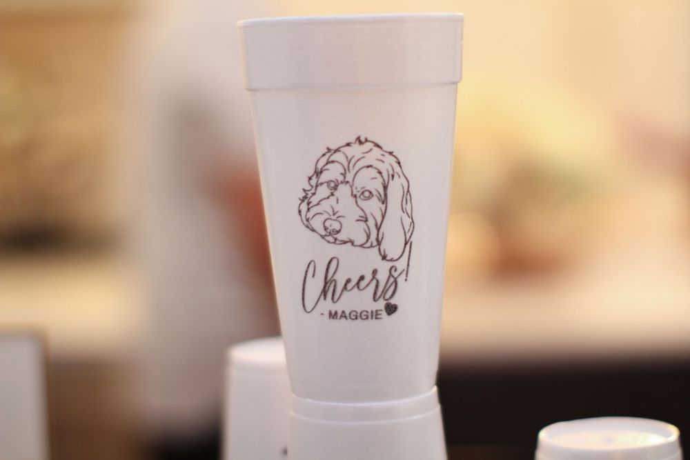 A white foam cup with a decorative 'Cheers' logo design featuring a turkey illustration.