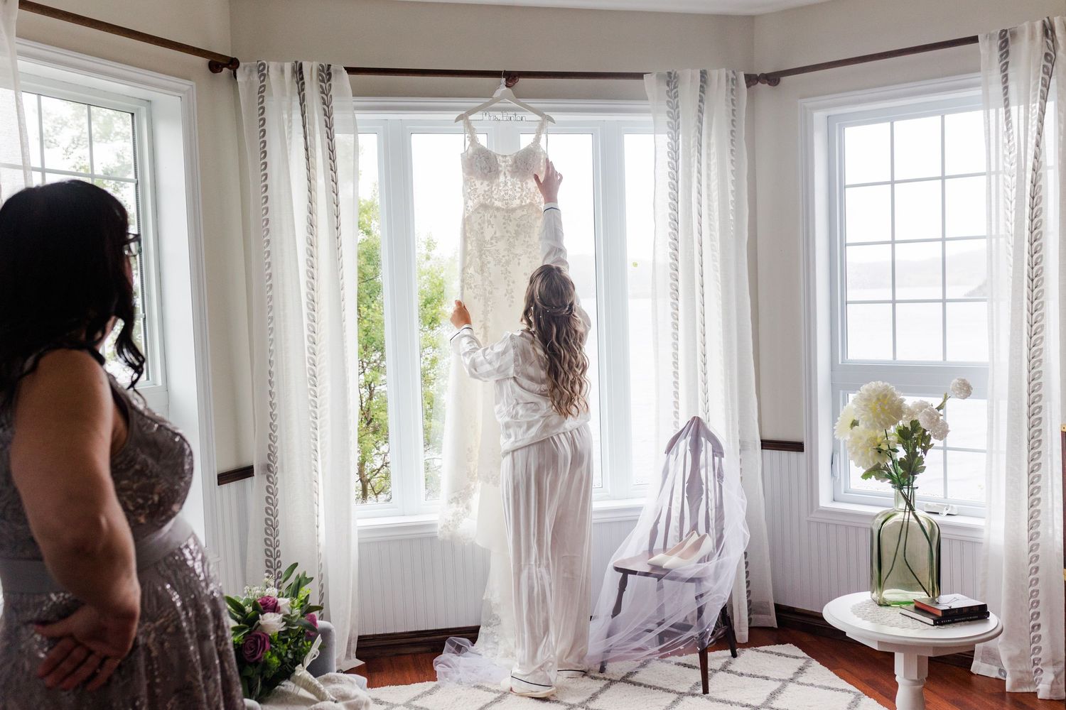 A series of white curtained windows in a bright living room letting natural light stream through sheer panels.