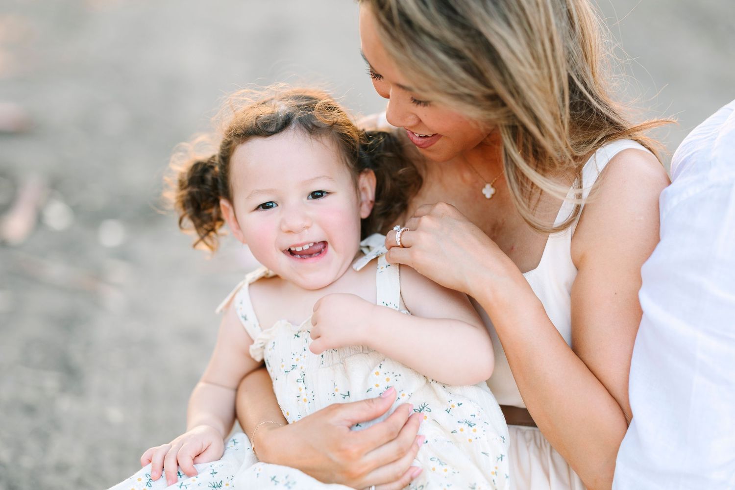 A tender moment shared between two people against a natural outdoor backdrop.