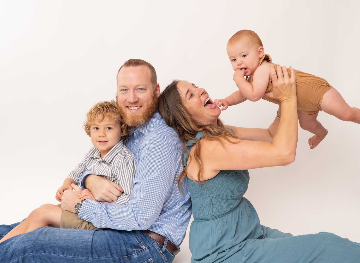 Lifestyle family photo session showing playful poses on white background.