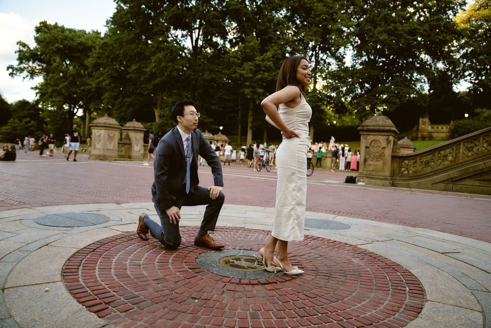 A couple poses on a circular brick patio during a romantic outdoor wedding photoshoot in Central Park.