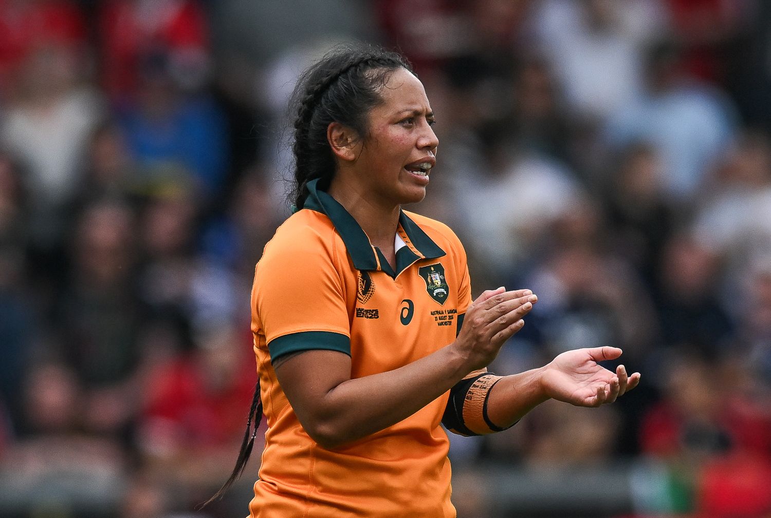 Athlete in orange jersey celebrates enthusiastically during competitive match with visible emotion and energy.