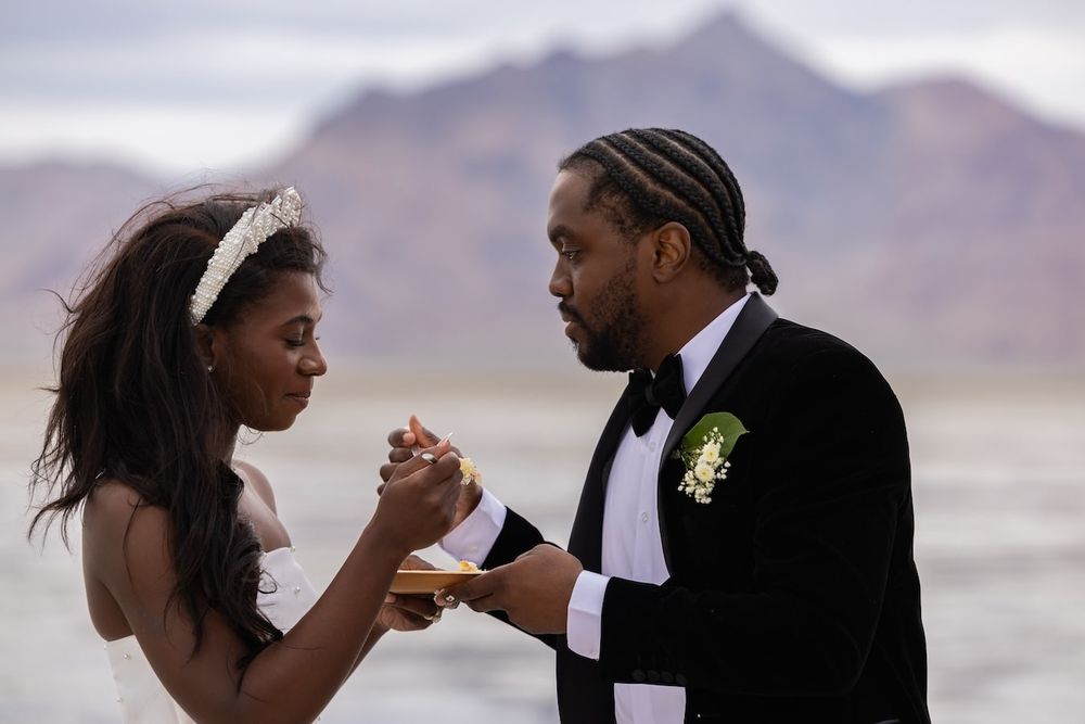 A romantic moment between newlyweds sharing a quiet dance together at their desert wedding with mountains in the background.