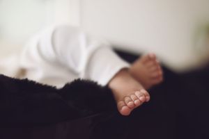 A series of black and white close-up photographs showing bare feet and toes in various positions and angles.