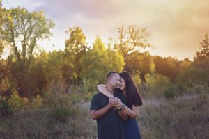 A sweet couple sharing an intimate moment together outdoors during golden hour.