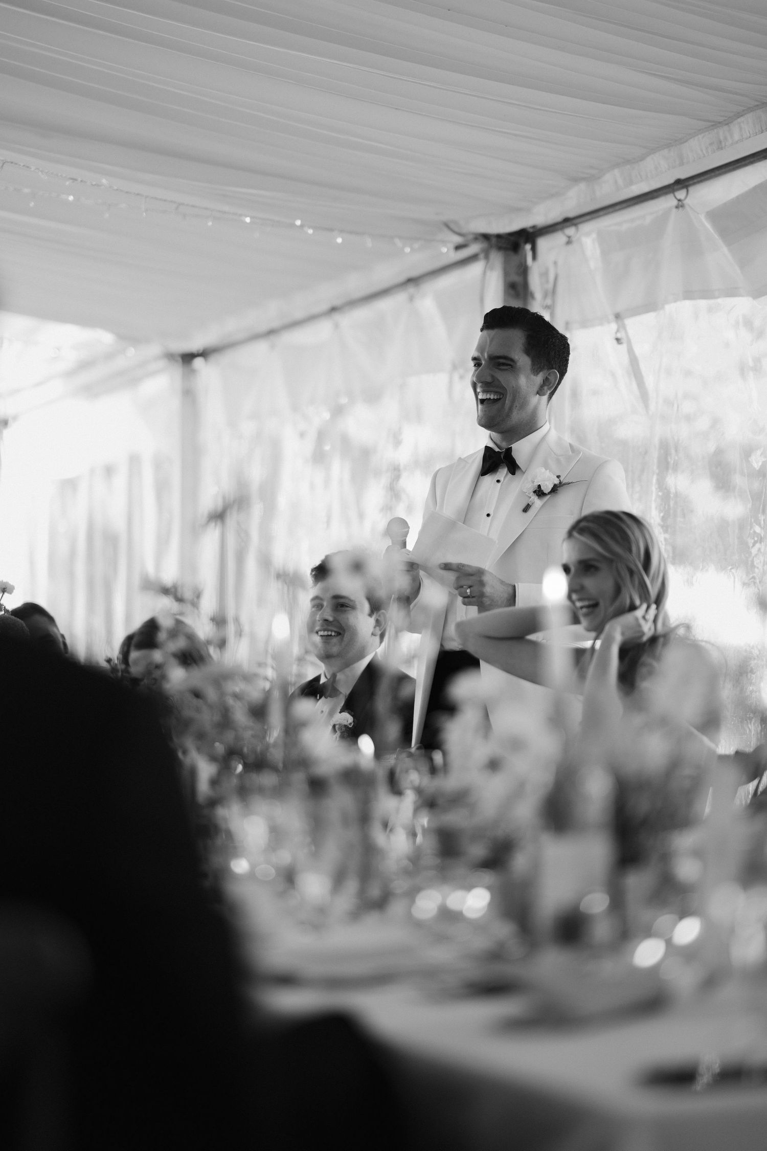 groom giving speech surrounded by guests laughing at hamswell house in bath