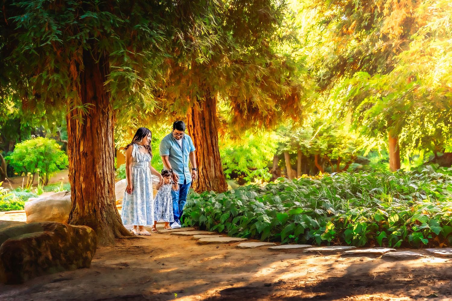 Fresno family parents walk hand in hand with their toddler, a heartfelt Central Valley storytelling session by colibri captures.