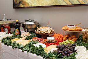 Elaborate charcuterie and cheese board spread with fresh vegetables and crackers.