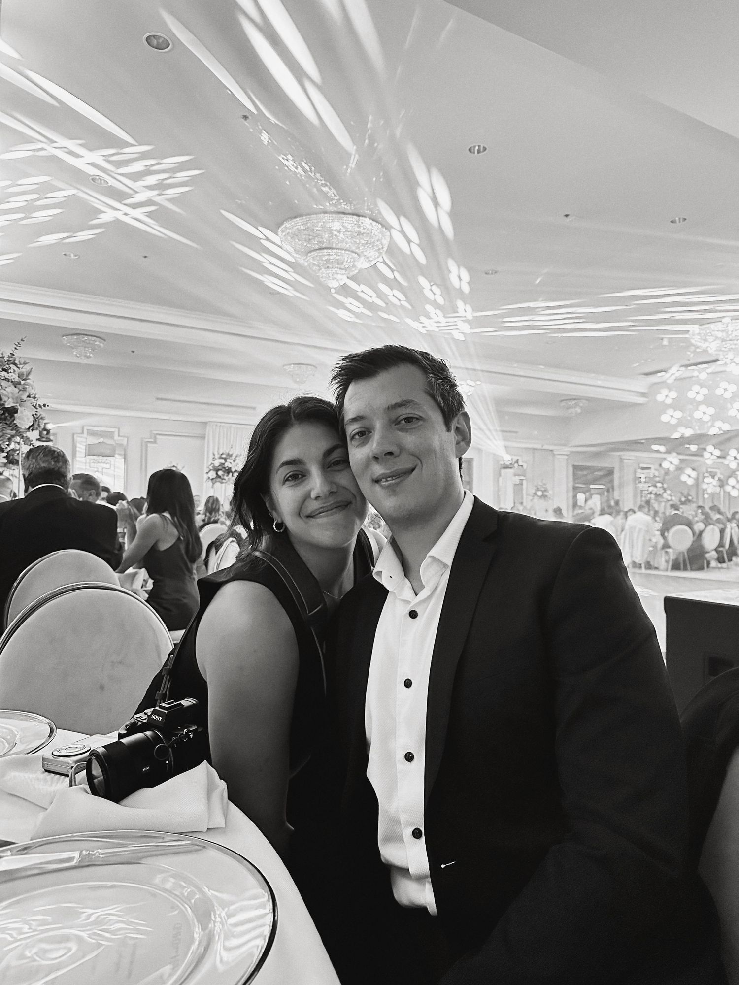 Black and white photos show people embracing and enjoying themselves at an elegant evening celebration in formal attire.