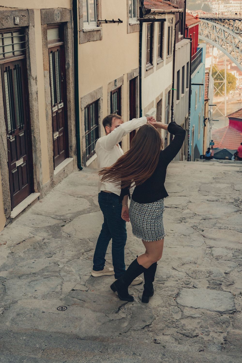 Playful moment on narrow cobblestone street in old town.