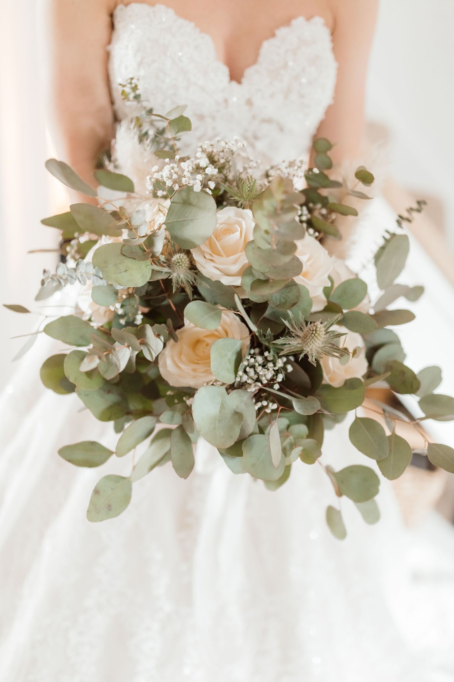 Close-up of an elegant bridal bouquet with white roses, eucalyptus leaves and delicate baby's breath. Photographer. Hull. East Yorkshire.