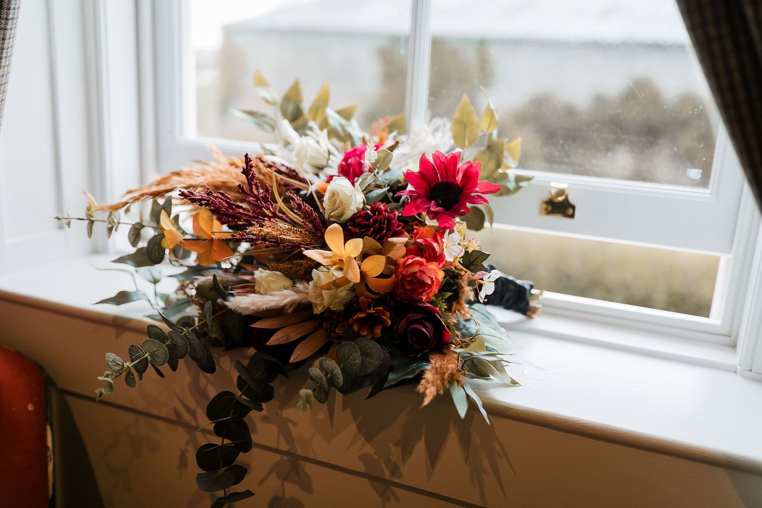 Decorative floral arrangements on a white windowsill create an elegant wedding ambiance. Photographer. Hull. East Yorkshire. Photography