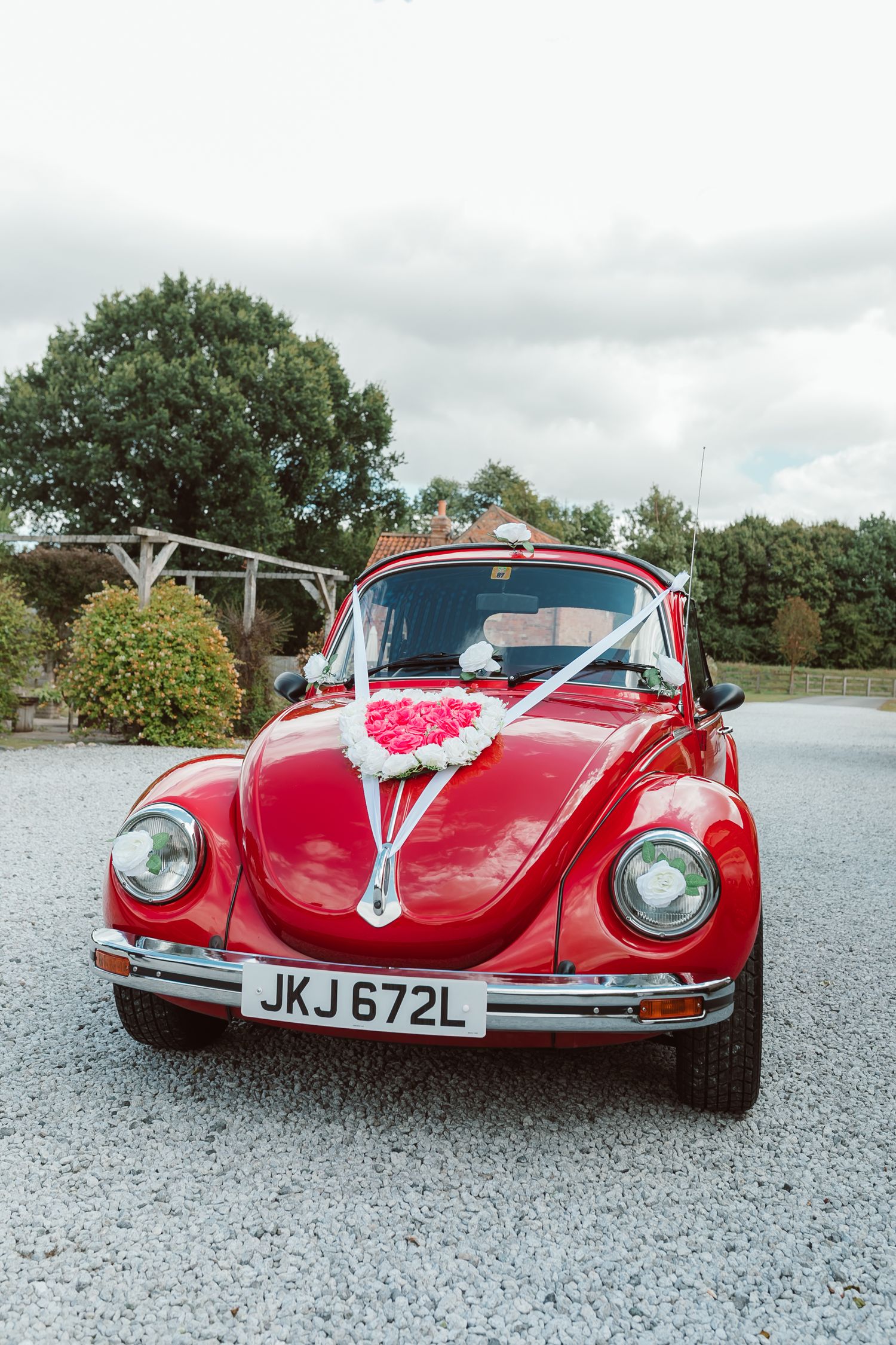 A classic red vintage car decorated with white ribbons for a wedding celebration. Photographer. Hull. East Yorkshire. Photography