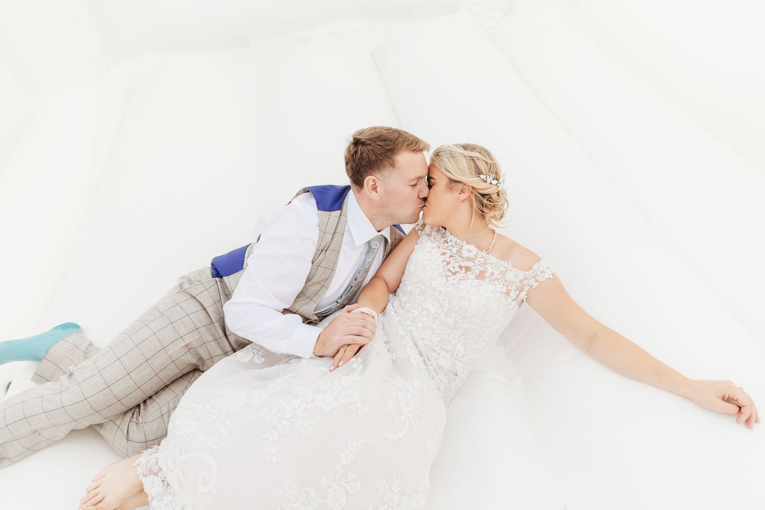 Romantic couple lying together on white background in wedding attire. Photographer. Hull. East Yorkshire. Photography