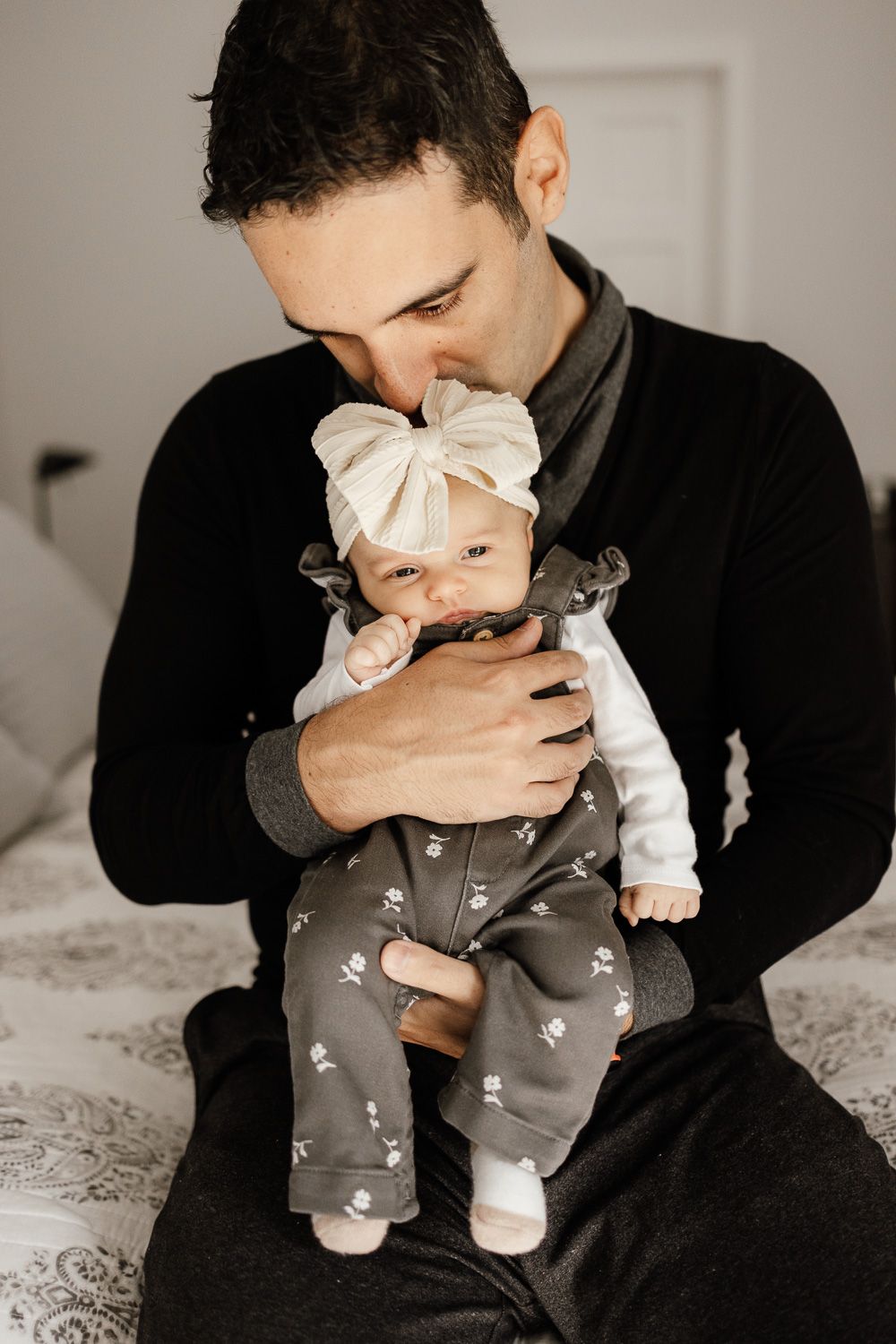 Father holding baby during their Bay Area in-home newborn photography session with Cindy Tucey Photography