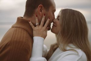 Side profile of couple in warm autumn clothing sharing a romantic moment.