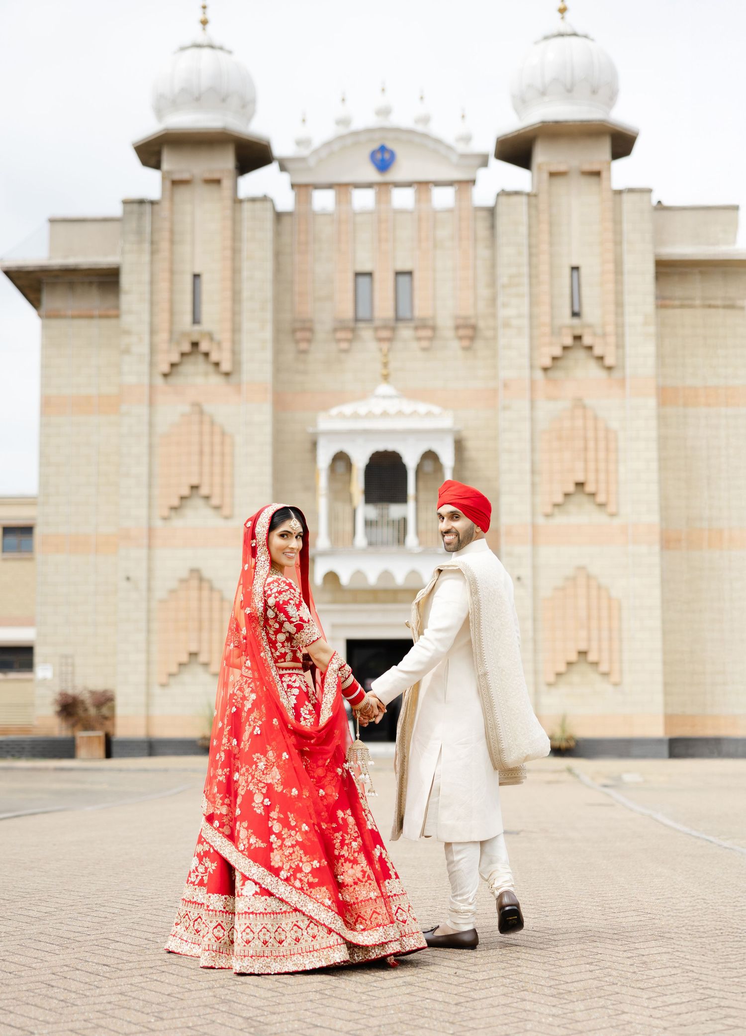 Newlywed Sikh couple in front of Hounslow Gurdwara