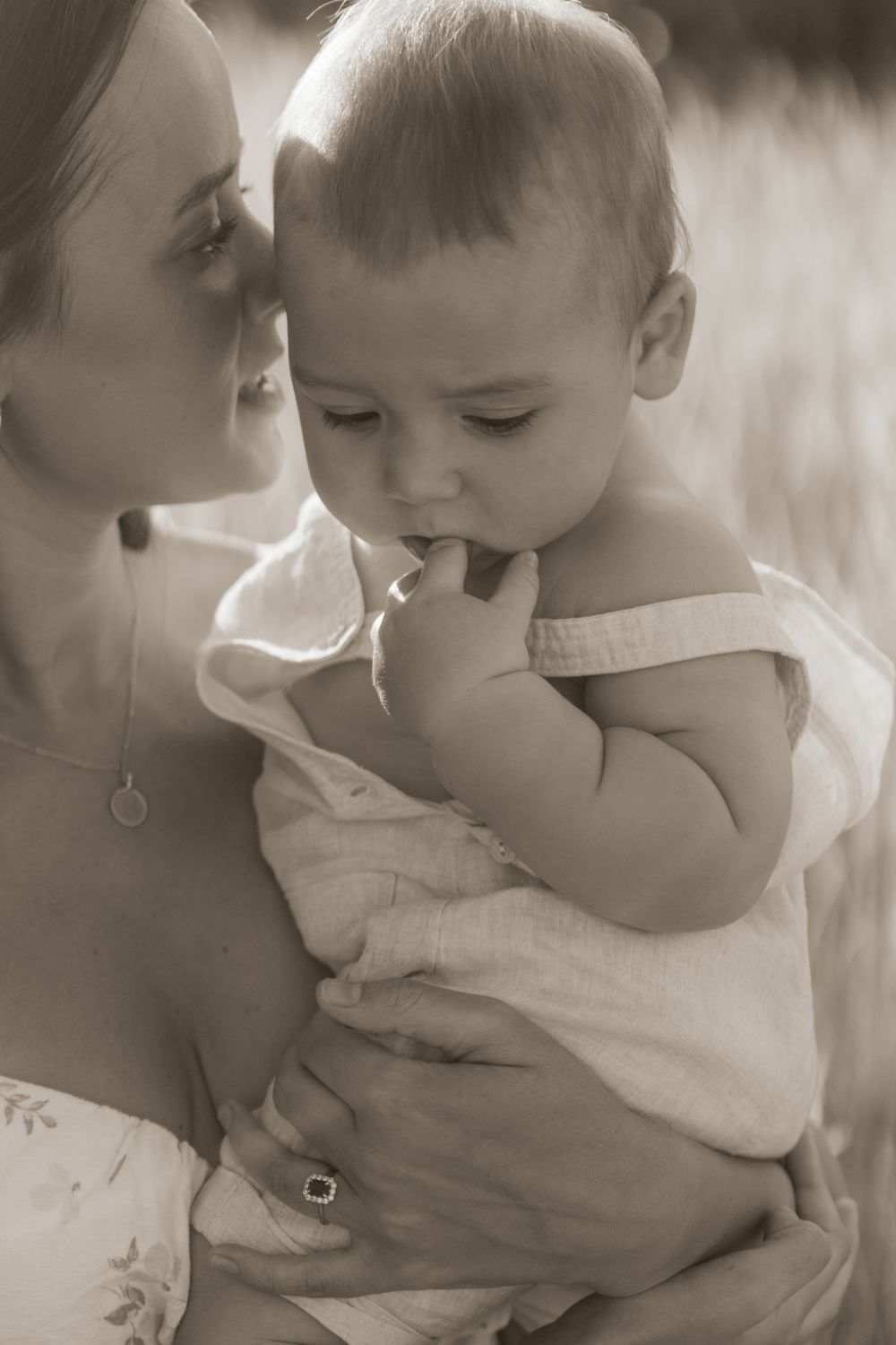 a mother in a candid moment with her baby captured by Northamptonshire Family Photographer Ellen Sear
