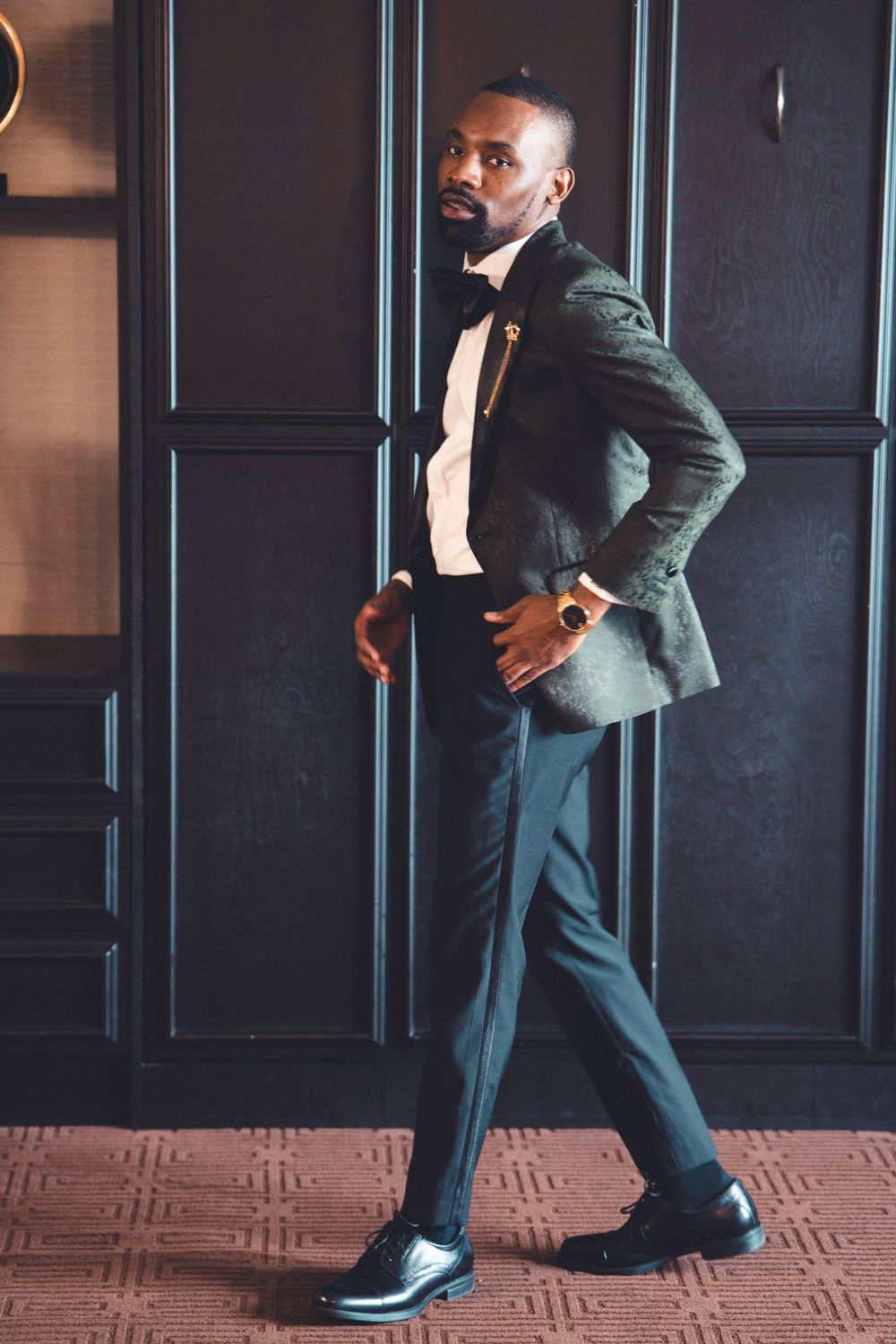 Multiple images showing stylish black Chelsea boots and green suit pants forming a sophisticated business look.