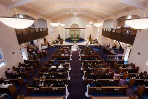 Interior view of a church sanctuary filled with wedding guests during a ceremony.