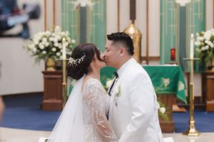 A tender moment between newlyweds during their church ceremony.