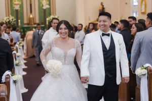 A happy couple walks down the church aisle after their wedding ceremony.