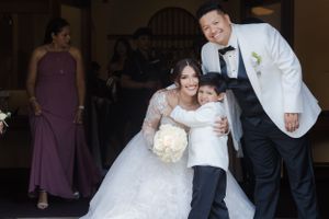 A heartwarming family moment at a wedding with elegant decor and lighting.