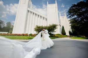 A flowing white wedding dress captured in front of a majestic white temple building.