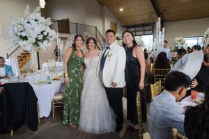 Wedding party celebrating in a rustic-modern venue with elegant decorations.