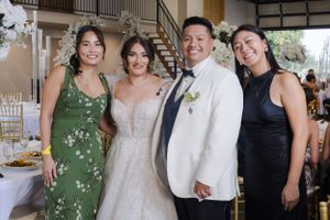 Wedding celebration with guests in formal attire at an indoor venue.