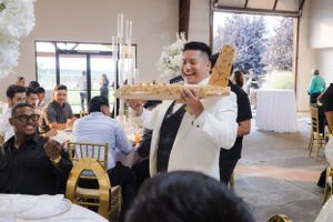 Wedding celebration in a modern venue with guests mingling and dancing.