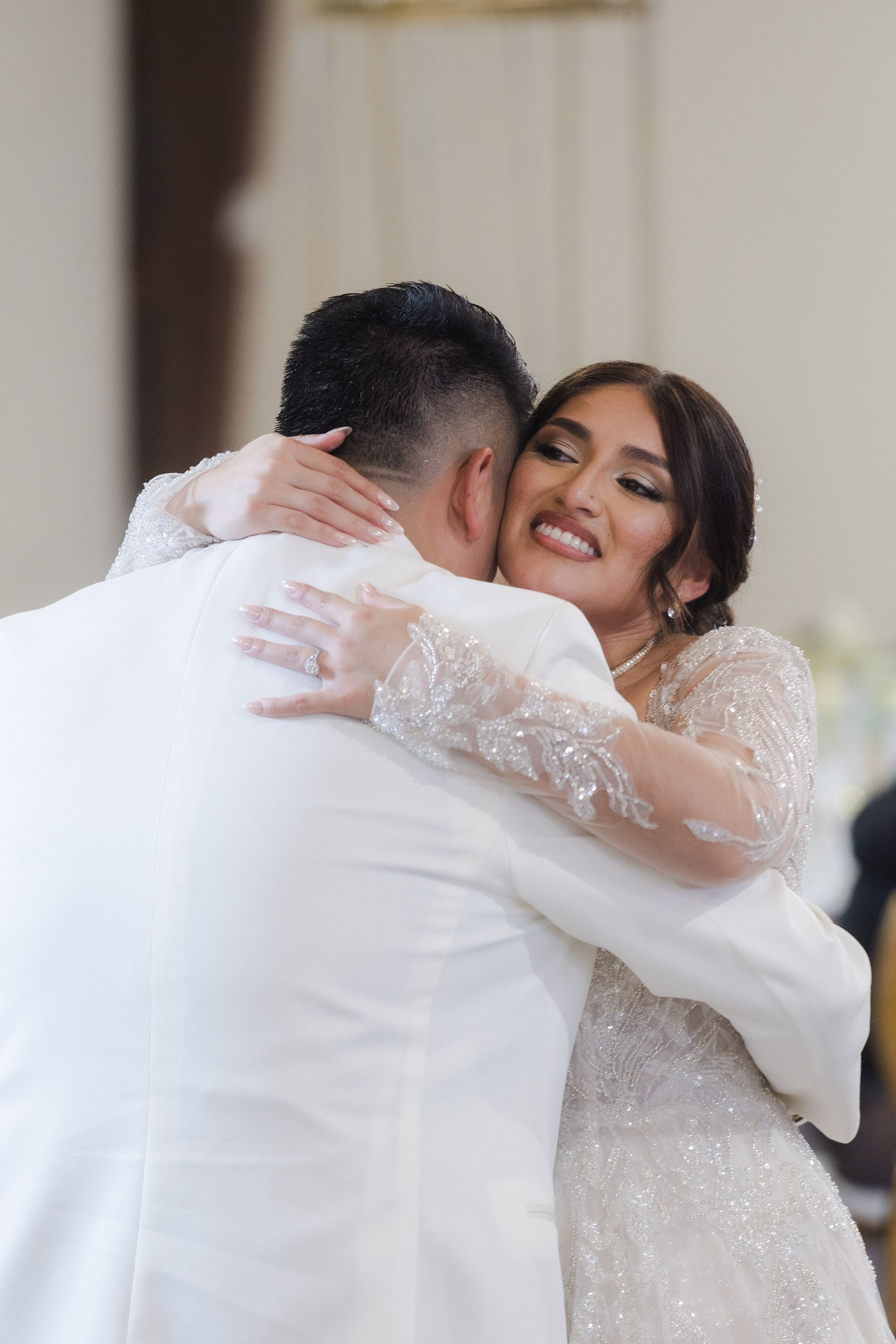 A romantic first dance moment at an elegant indoor wedding reception.