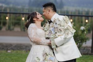 A couple shares an intimate moment during their wedding photoshoot with scenic outdoor views.
