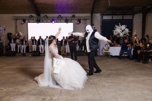 Wedding reception venue with decorative lighting and guests gathered on the dance floor.