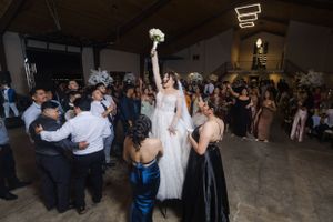 Evening reception party with guests dancing under ambient lighting.
