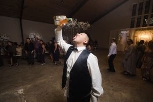 Couples dancing together at evening wedding reception with moody lighting.