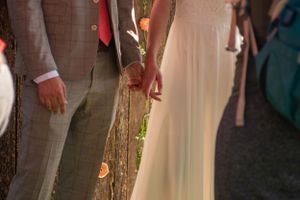 Bride and groom hold hands on their wedding day in a backyard wedding in Rexburg, Idaho.