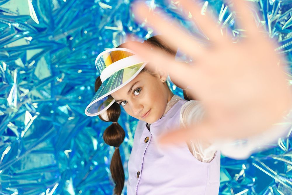 Motion blur portrait with blue background creating dynamic effect.