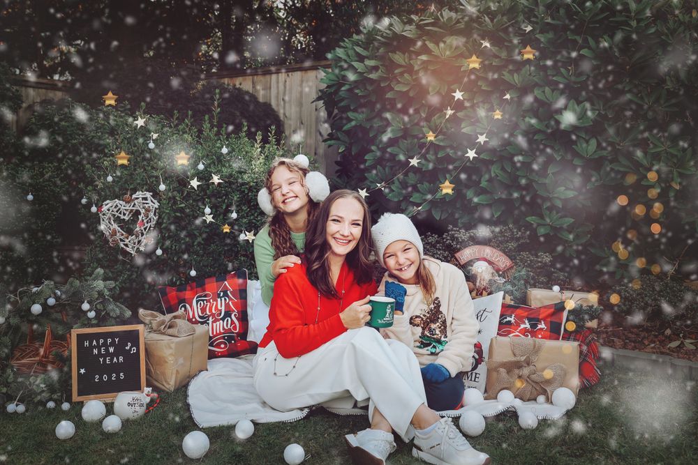A festive outdoor photo setup with winter decor and falling snow effect.