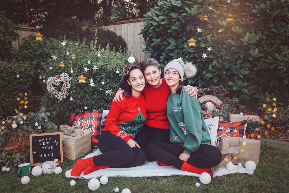 Christmas themed photo with holiday decorations and wrapped presents in garden setting.