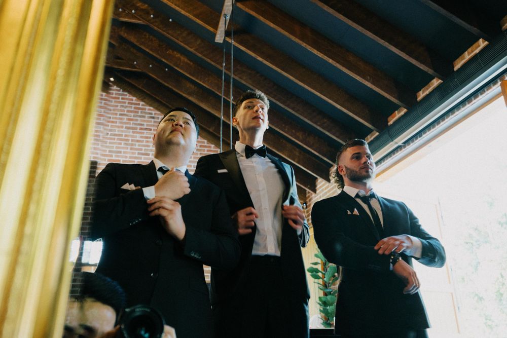Groom adjusts suit at Queensland's The Valley Estate, Brisbane wedding photography at its finest
