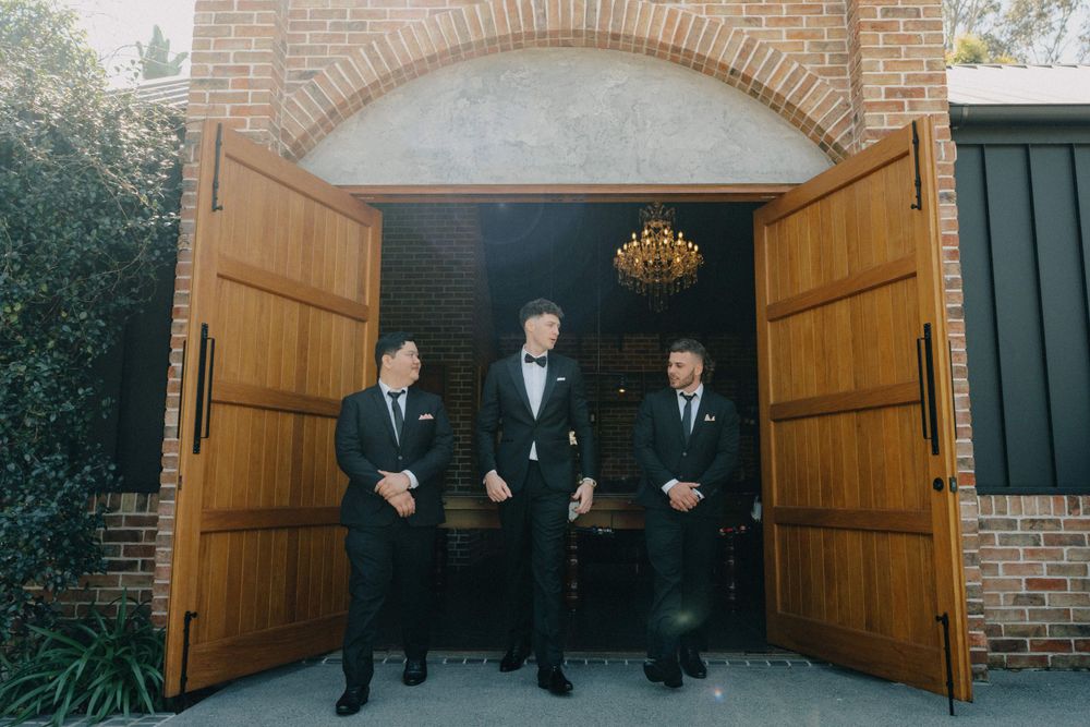 Groomsmen share laugh at The Valley Estate, Gold Coast wedding photography catches candid moment