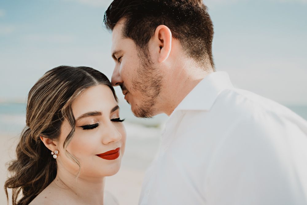 Groom about to kiss the bride's forehead, a joyful moment filled with love during their pre-wedding session