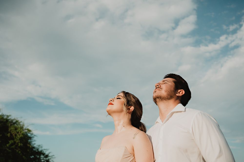Couple looking up at the sky, enjoying a serene moment together, showcasing their joyful love story in Mazatlán