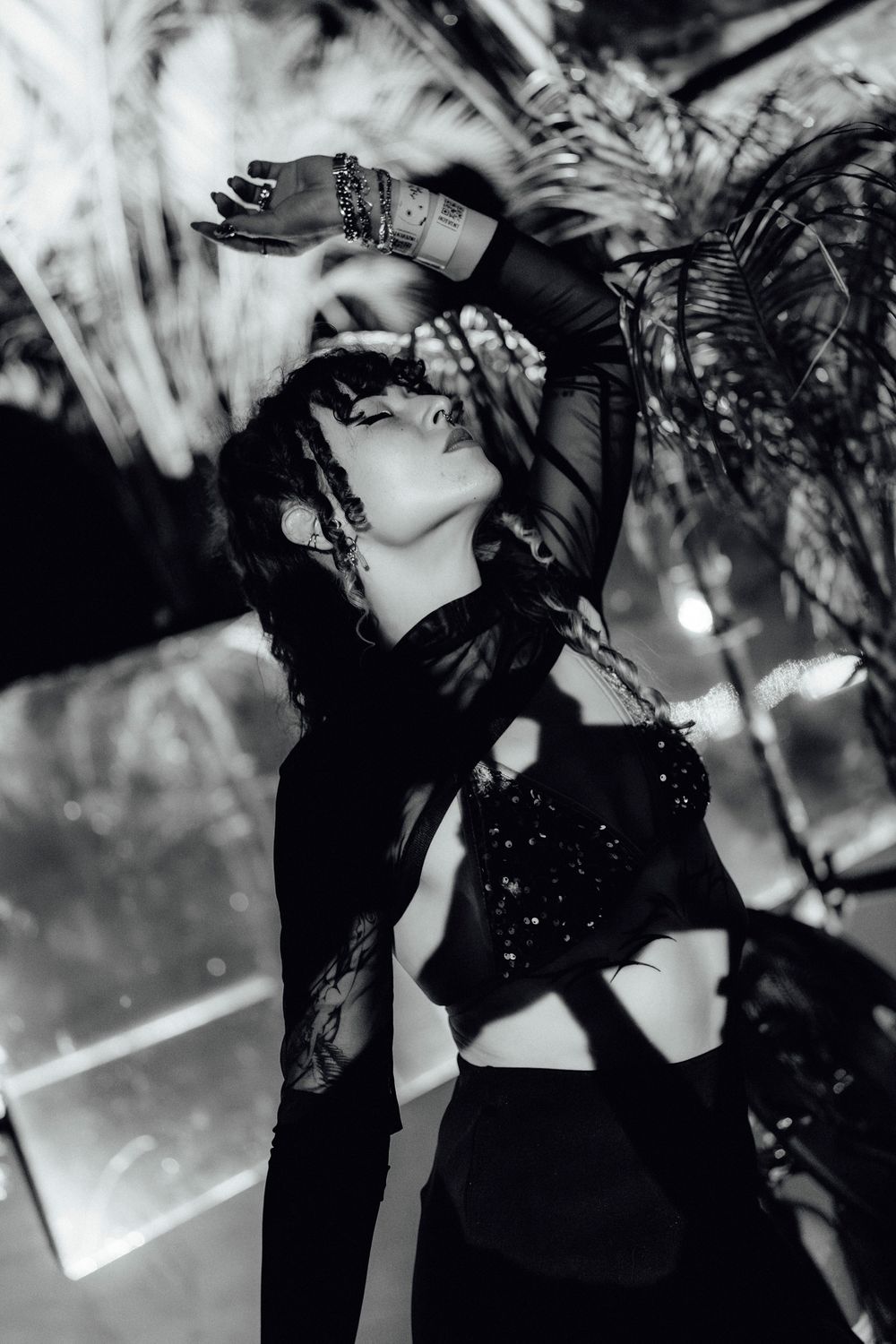 Dynamic black and white performance footage from a dramatic concert stage show.